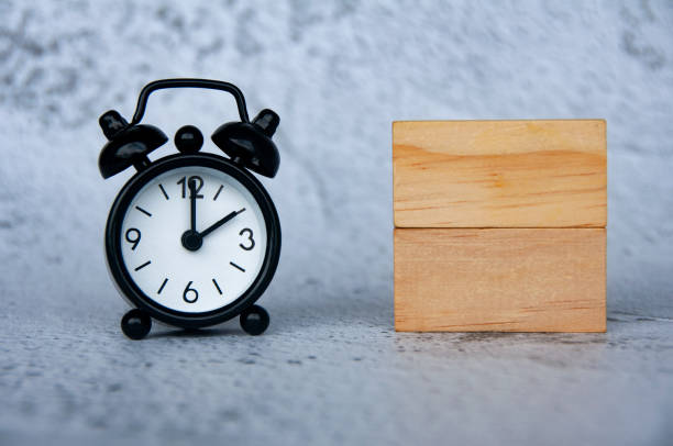 istock Alarm clock with wooden blocks with customizable space for text. Copy space 1496010135