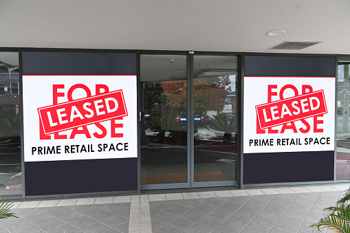 Two prime retail for lease signs with a leased sticker over the top