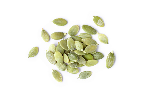 Pumpkin seeds isolated on white background. Top view. Flat lay.