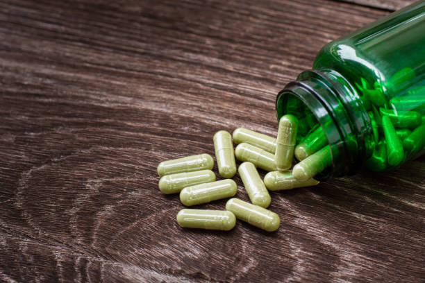 istock green herbal powder medicine capsules pills 1496010536