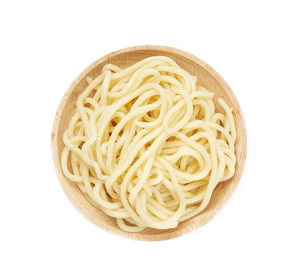 top view flat lay overhead udon ramen noodle in wood plate isolated on white background. pile of udon ramen noodle isolated. heap of udon ramen noodle isolated