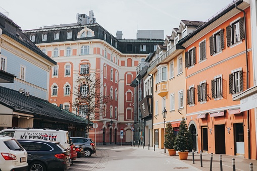 Salzburg, Austria - 7 August, 2019: wide angle color image depicting the old fashioned streets and luxury stores of Salzburg, Austria. Many people and tourists are walking the cobbled streets, exploring the charming atmosphere of this Austrian city.