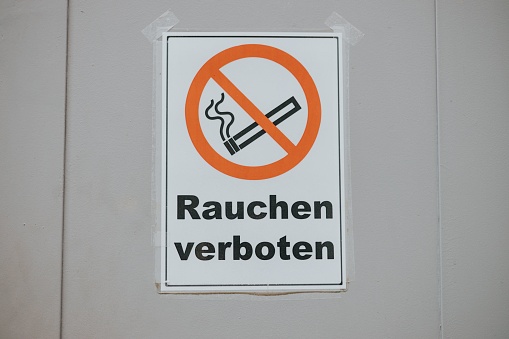 A white door with a bold black 'No Smoking' message in German language