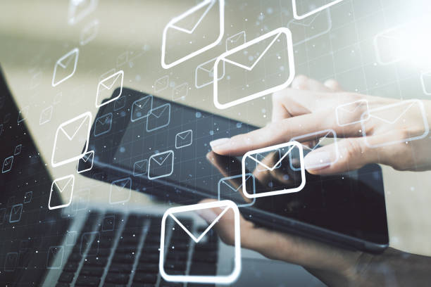 istock Creative abstract postal envelopes sketch and hand working with a digital tablet on background, e-mail and marketing concept. Double exposure 1496019826