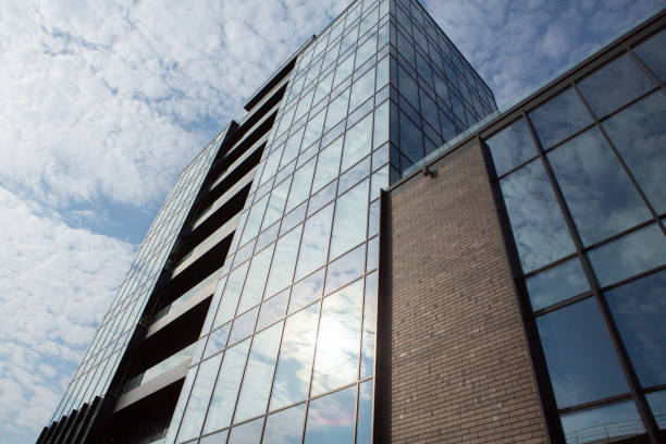 istock Modern office building with glass facade and blue sky. 1496021386