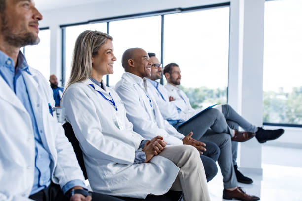istock Happy medical experts attending an education event in board room. 1496032807