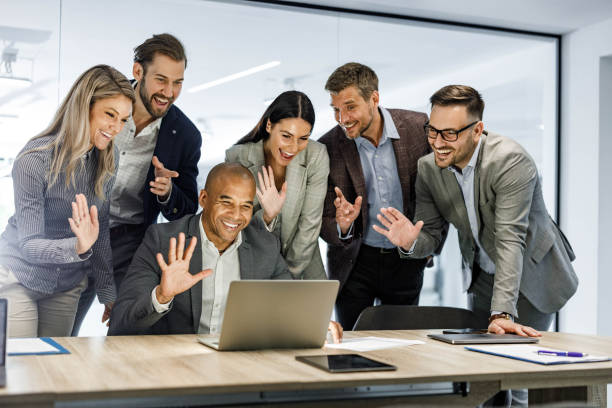 istock Happy business team greeting someone on conference call in the office. 1496032821