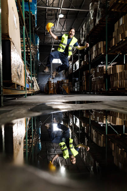 istock Cheerful manual worker jumping of joy in distribution warehouse. 1496033341