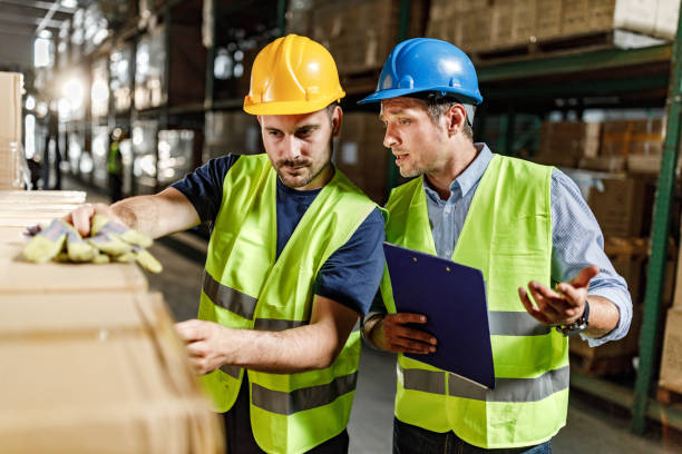 istock Manager giving instructions to his worker in distribution warehouse. 1496034056