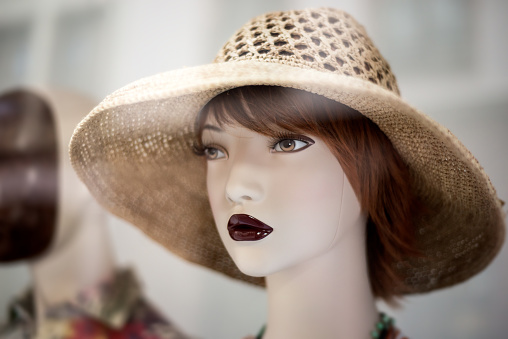 Closeup of summer hat on the head of mannequin in a fashion store showroom