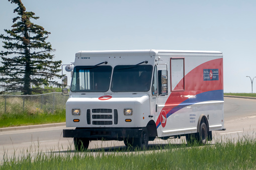 Calgary, Alberta, Canada. Jun 4, 2023. A Canada Post delivery truck on the route during the spring.