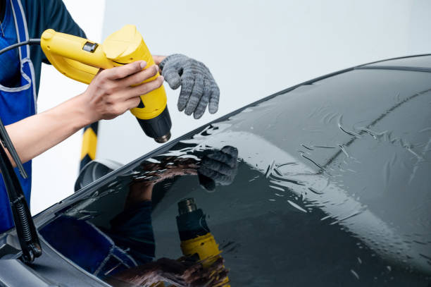 istock Car front windscreen film removal and tinting installation 1496045471