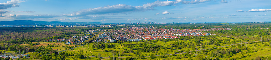 Drone panorama over the outskirts of Frankfurt with the city of Moerfelden-Walldorf and the airport during the day in springtime