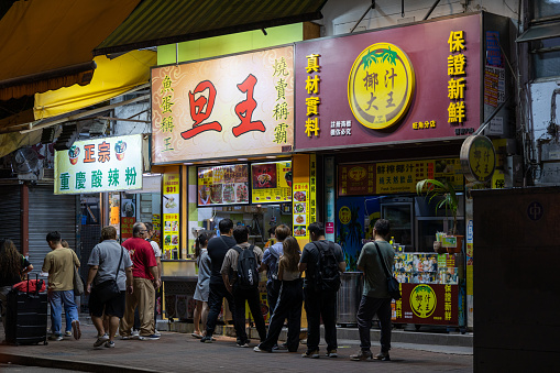 Hong Kong - June 2, 2023 : People at the street food restaurants in Mong Kok, Kowloon, Hong Kong.