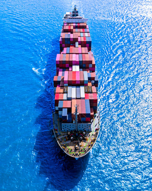 istock Aerial front view container cargo vessel traveling over calm ocean. 1496049537