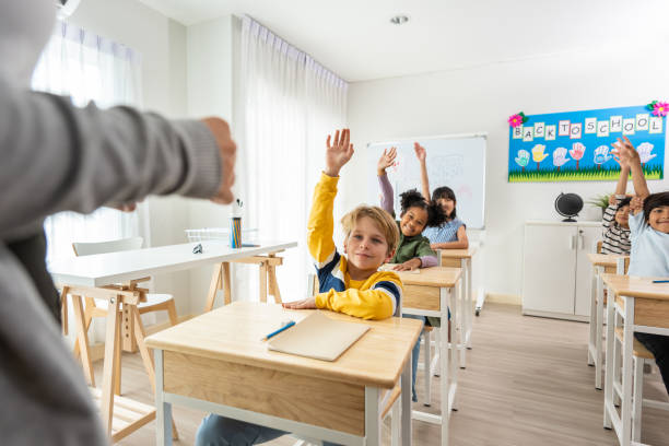 istock Group of student learn with teacher in classroom at elementary school. Attractive beautiful female instructor master explain and educate young children with happiness and fun activity at kindergarten. 1496049640
