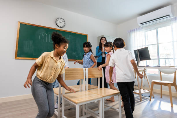 istock Group of student learn with teacher in classroom at elementary school. Attractive beautiful female instructor master explain and educate young children with happiness and fun activity at kindergarten. 1496049672
