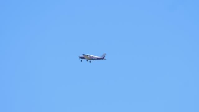 Small Airplane Gliding High in the Clear Blue Sky in 4k slow motion 60fps