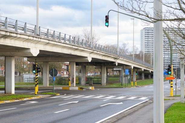 istock Intersection with a three-lane branching on the sides in the city. Hinged traffic light 1496052330