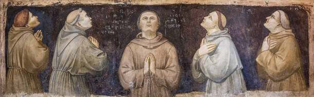 A beautiful fresco by Cimabue inside the Basilica Inferiore di San Francesco in the medieval town of Assisi in Umbria The detail of a fresco by Cimabue inside the Basilica Inferiore di San Francesco (Upper Basilica of San Francesco), in the medieval heart of Assisi, in Umbria. Built in the Italian Gothic style starting from 1228 and completed in 1253, the Basilica preserves the mortal remains of the Saint of the Poor since 1230. The construction of the Basilica consists of a Lower Basilica and an Upper Basilica, perfectly integrated. Over the centuries Assisi and the spirituality of its sacred places have become a symbol of peace, a point of reference for tolerance and solidarity between peoples and between the different confessions of the world. The Umbria region, considered the green lung of Italy for its wooded mountains, is characterized by a perfect integration between nature and the presence of man, in a context of environmental sustainability and healthy life. In addition to its immense artistic and historical heritage, Umbria is famous for its food and wine production and for the high quality of the olive oil produced in these lands. Since 2000 the Basilica and other Franciscan sites of Assisi have been declared a World Heritage Site by UNESCO. Image in high definition format. medieval fresco stock pictures, royalty-free photos & images