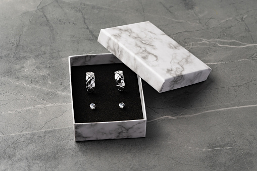 Jewelry box with earrings on a gray background close up