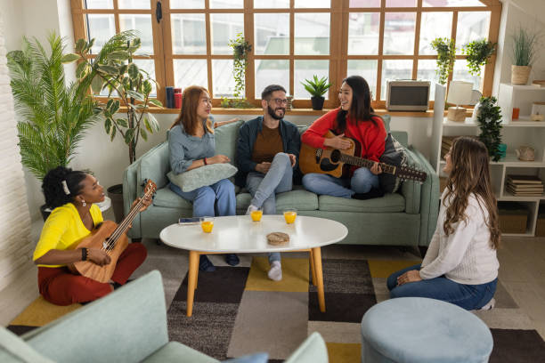 istock Group of friends relaxing and playing instruments at home 1496054147