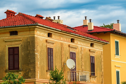 Lovran architecture, old building with vintage window shutters. Lovran is a town in croatian Kvarner bay of Adriatic sea, touristic travel destination with distinctive Istrian architectural style.