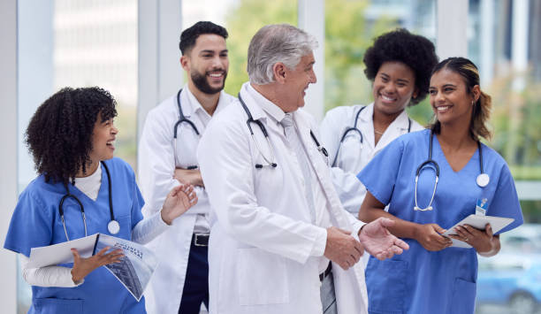 istock Doctors, nurses or laughing in hospital diversity, teamwork or collaboration for team building, bonding or people support. Smile, happy or healthcare workers in funny joke, comic meme or group comedy 1496054565