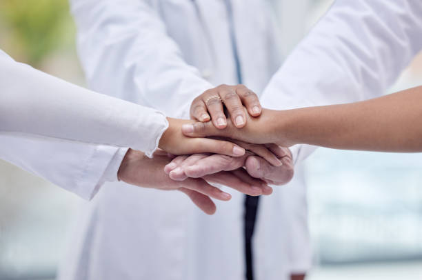 istock Doctors, nurses or hands stack in hospital motivation, team building or medical mission for goals, community or support. Zoom, women or healthcare diversity in teamwork circle or collaboration huddle 1496054582