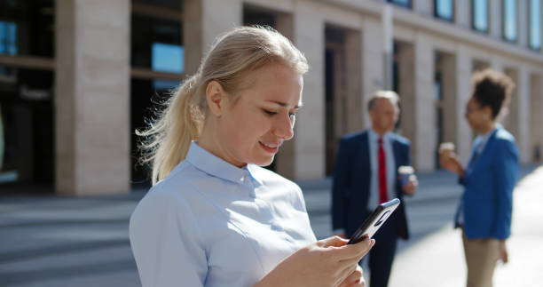 istock Successful businesswoman using app technologies on smartphone during lunch break outside office 1496057503