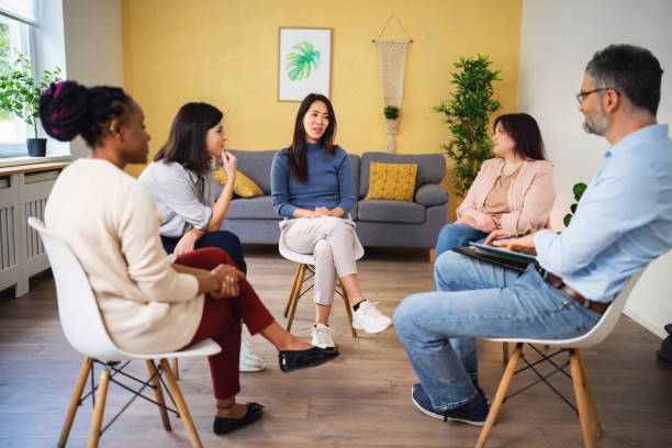 istock During multiracial group therapy, woman Japanese ethnicity, sharing her thoughts and emotions 1496059171