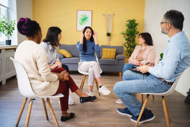 istock During multiracial group therapy, woman Japanese ethnicity, sharing her thoughts and emotions 1496059193