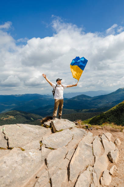istock A tourist on the mountains with a ukrainian flag 1496059194