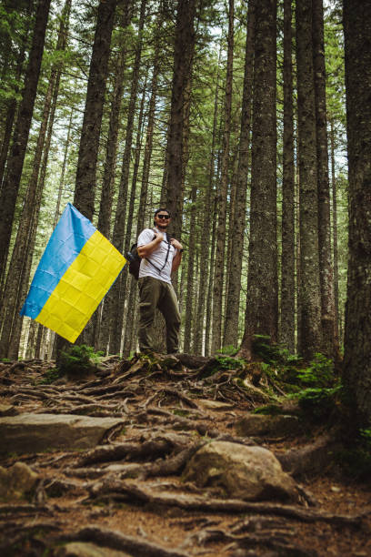 istock A man in the forest with a ukrainian flag 1496059203