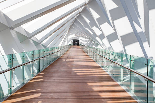 Dubai, UAE  april 05, 2023: Dubai Water Canal Foot Bridge at day, internal pedestrian part, boardwalk, squares, elevator at the end