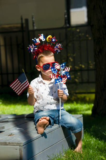 istock A little boy sits on a park bench on a sunny summer day. 1496064788