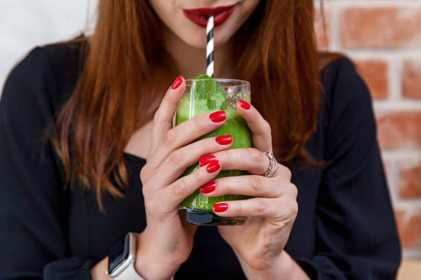 istock Girl drinking spinach, avocado and mint smoothie 1496064968