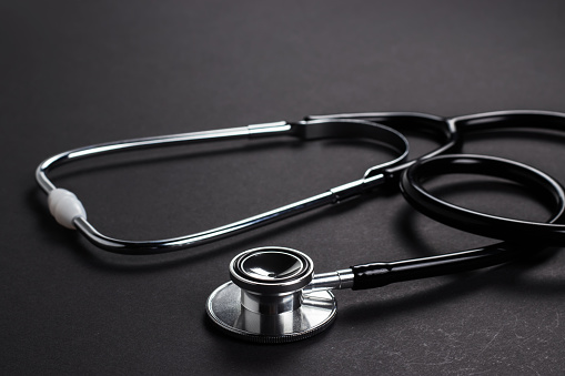 Stethoscope on black background with space for text - health concept. Medical conceptual.