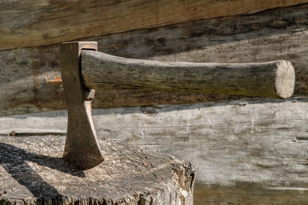 Break while chopping wood. A hatchet is stuck in a chopping block.