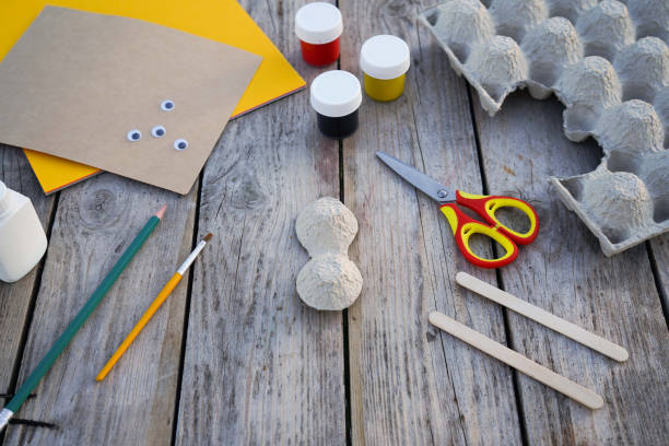 istock Step by step diy process. Step 3- we cut out a honey bee figurine from an egg cardboard box. Creativity, crafting. Zero waste concept. 1496068166