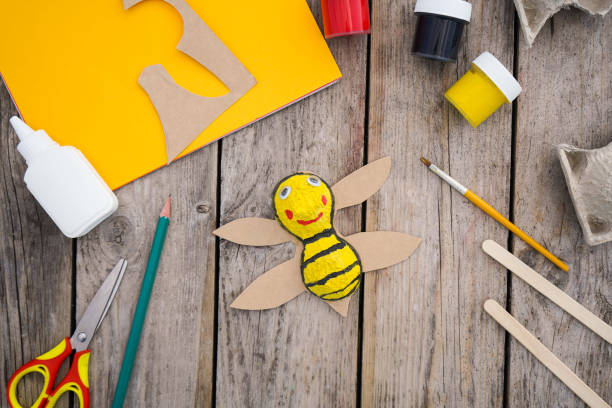 istock Handmade craft a honey bee toy from a cardboard egg tray. Creativity, crafting. Zero waste concept. 1496068208