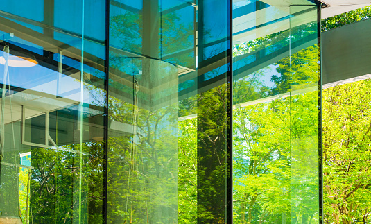Eco-friendly glass building facade in the modern city, Go green concept.