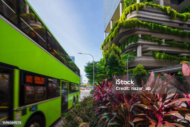 Electric Bus Passing Along The Park Royal Hotel Eco Building In Singapore Stock Photo - Download Image Now