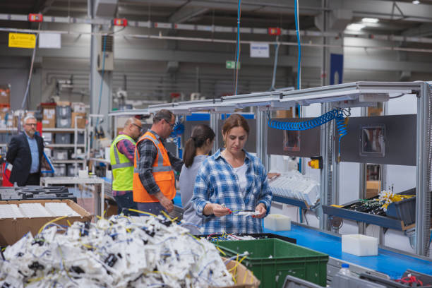 istock Group of workers working on the production line in factory 1496069938