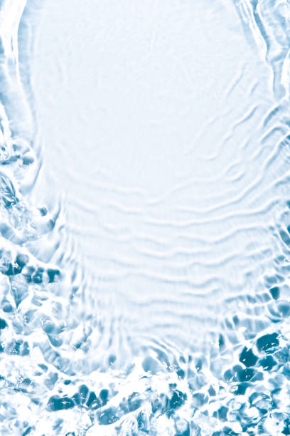 The texture of water on a white background in bright sunlight.