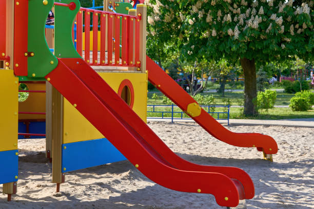 istock Summer spring children's playground with painted toy slide in park 1496072192