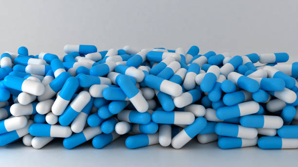 Big stack of blue medical pills and capsules stock photo