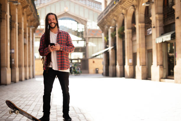istock Happy smiling skater using the phone 1496075994