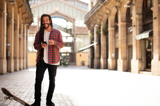 istock Happy smiling skater using the phone 1496076533