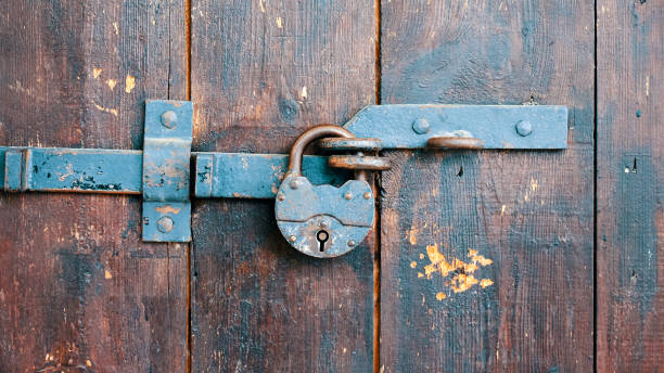 Rusty padlock on an old wooden door